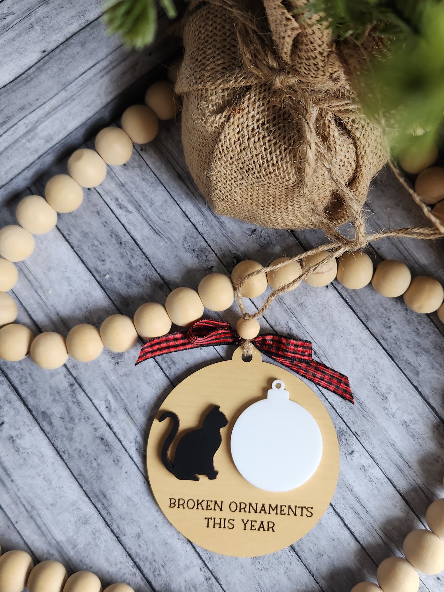 Wooden bead garland with a decorative tag on a wooden surface