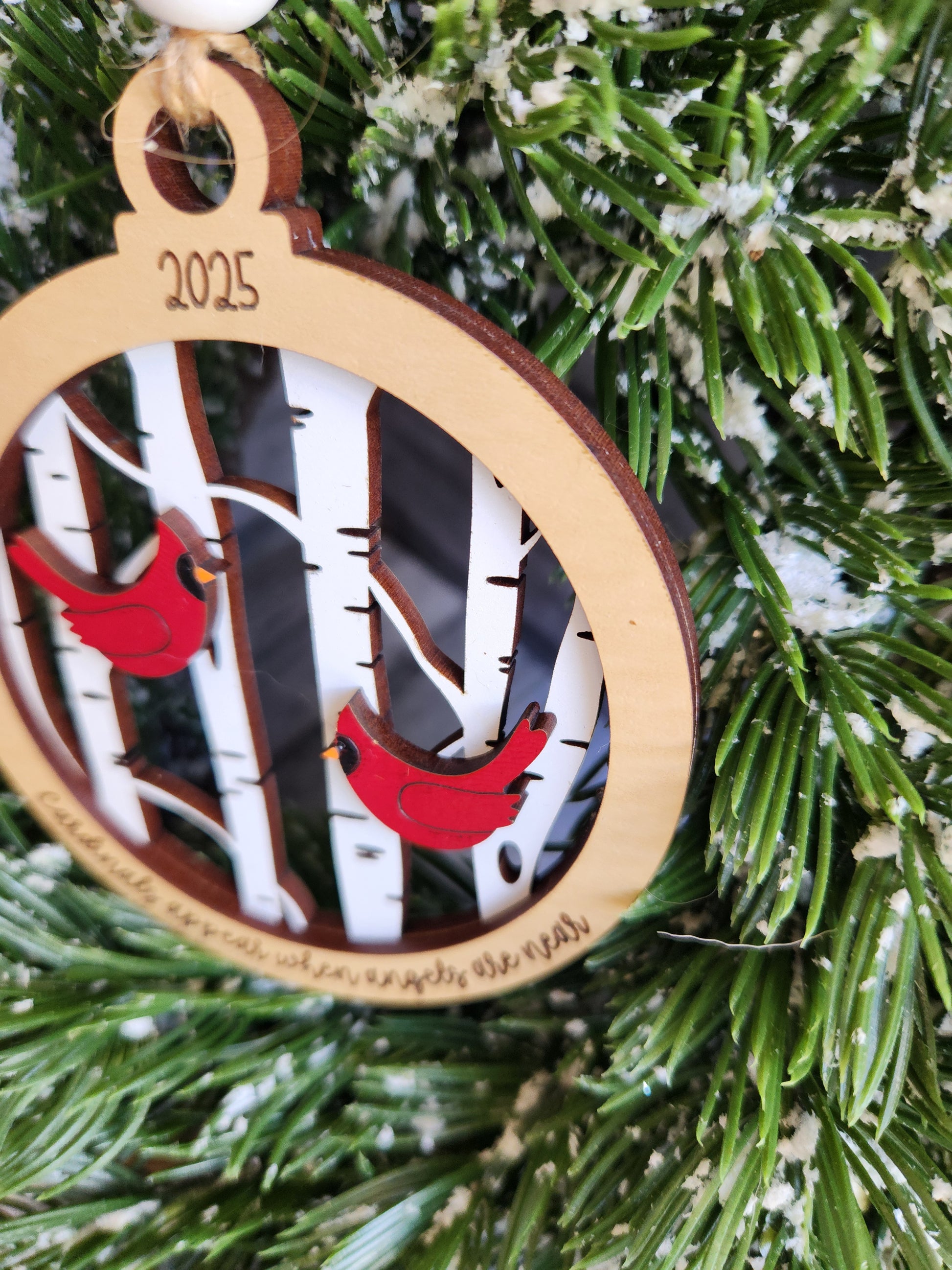 Decorative Christmas ornament with cardinal design on a tree